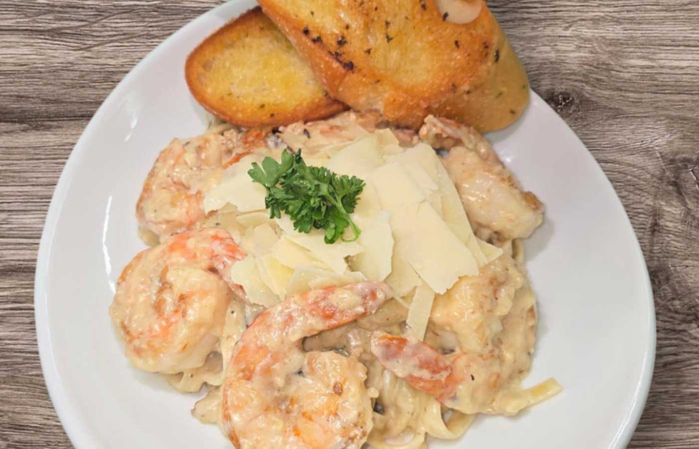 Shrimp alfredo and garlic bread served at Matera Grill and Italian Restaurant in Escanaba, MI