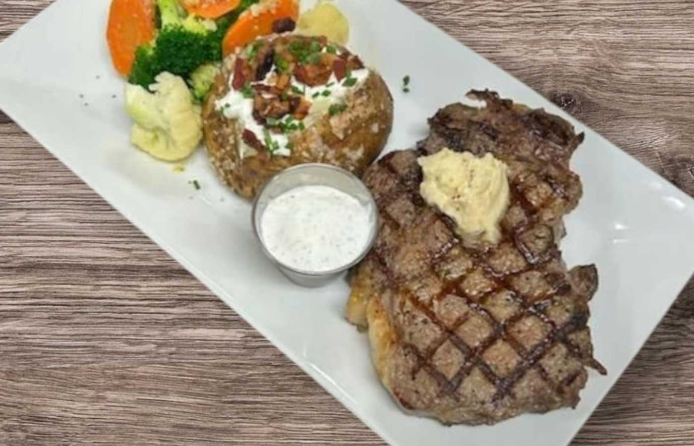 Ribeye steak with side mashed potato and veggies served at Matera Grill and Italian Restaurant in Escanaba, MI