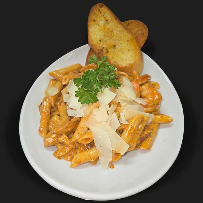 Penne pasta topped with parmesan cheese served at Matera Grill and Italian Restaurant in Escanaba, MI Penne pasta topped with parmesan cheese served at Matera Grill and Italian Restaurant in Escanaba, MI