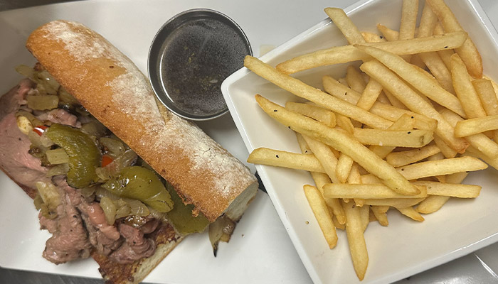 A Matera Italian Menu specialty: roast beef sandwich, fries, and au jus in Escanaba.